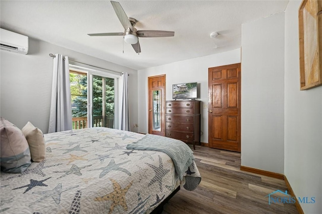 bedroom featuring a ceiling fan, wood finished floors, access to outside, a wall mounted air conditioner, and baseboards