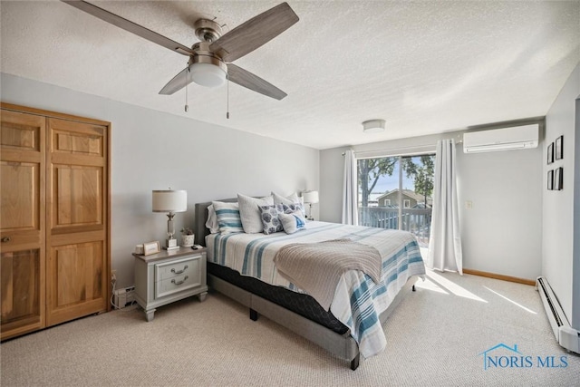 bedroom with access to exterior, a baseboard radiator, light colored carpet, a textured ceiling, and a wall mounted air conditioner