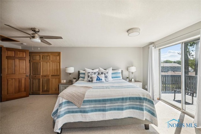 bedroom featuring light carpet and access to outside