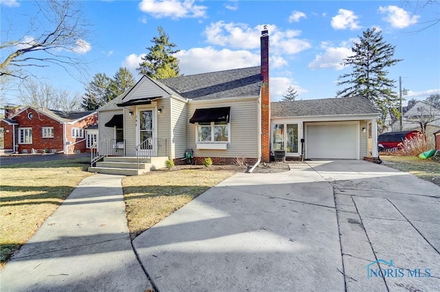 view of front of home featuring driveway, an attached garage, a chimney, a shingled roof, and a front lawn