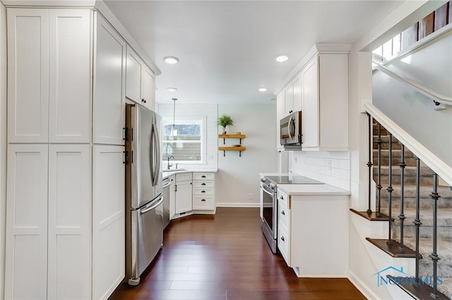kitchen with open shelves, appliances with stainless steel finishes, a sink, white cabinetry, and recessed lighting