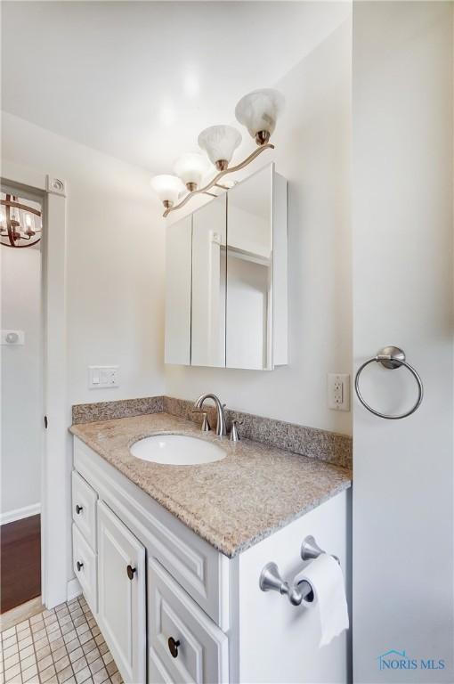 bathroom with vanity and a chandelier