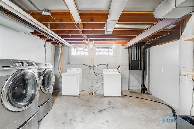 below grade area featuring washing machine and clothes dryer
