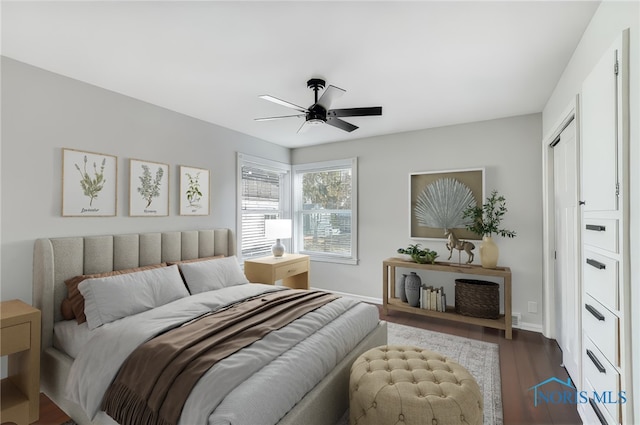 bedroom with baseboards, dark wood-style flooring, and ceiling fan