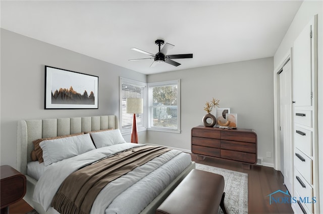 bedroom featuring baseboards, ceiling fan, and wood finished floors
