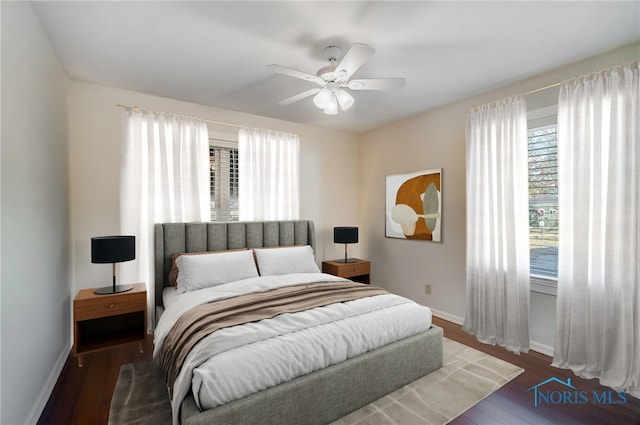 bedroom featuring baseboards, a ceiling fan, and wood finished floors