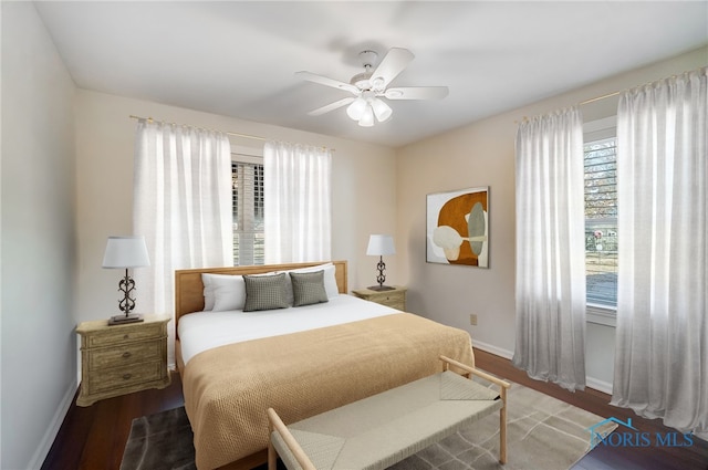 bedroom with baseboards, a ceiling fan, and wood finished floors