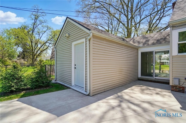view of outbuilding featuring fence