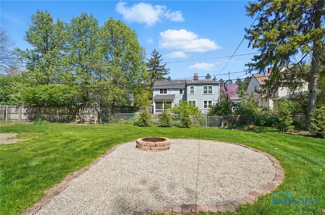 view of yard featuring fence and an outdoor fire pit