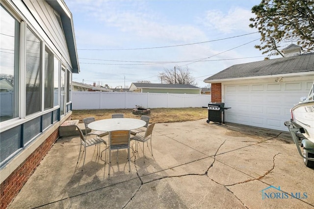 view of patio with outdoor dining area, a grill, and fence