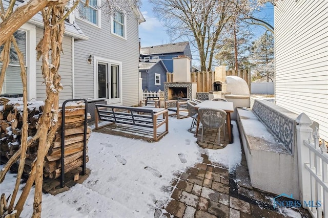 view of patio with fence and an outdoor fireplace