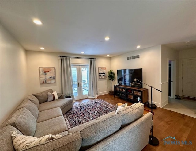 living room featuring recessed lighting, visible vents, wood finished floors, and french doors