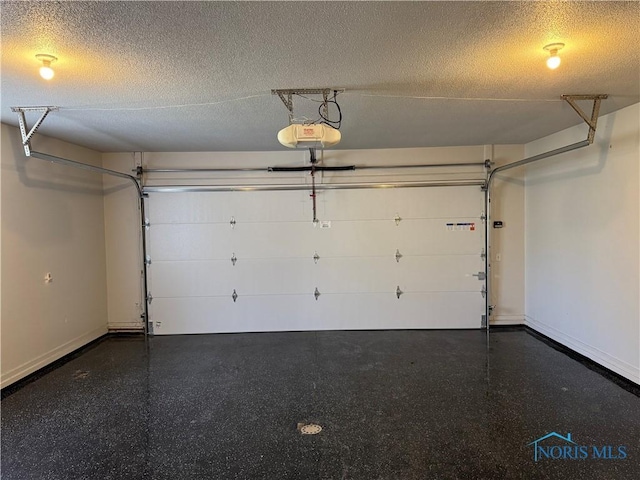 garage with a garage door opener and baseboards