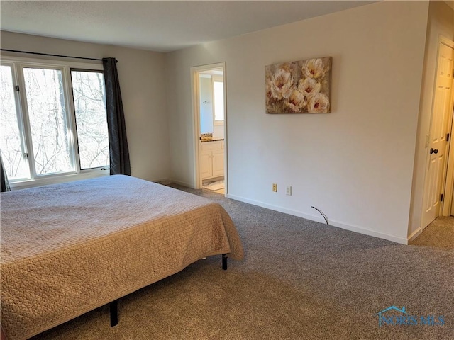 bedroom featuring carpet floors, baseboards, and connected bathroom