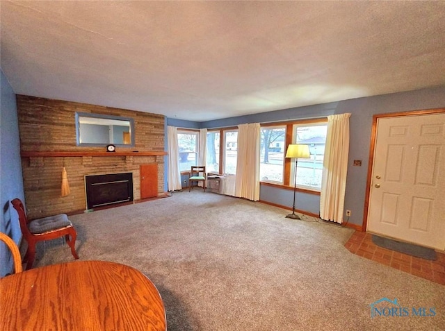 1934 Geffs Ave, Findlay, OH 45840 - carpeted living room with baseboards, a textured ceiling, and a fireplace