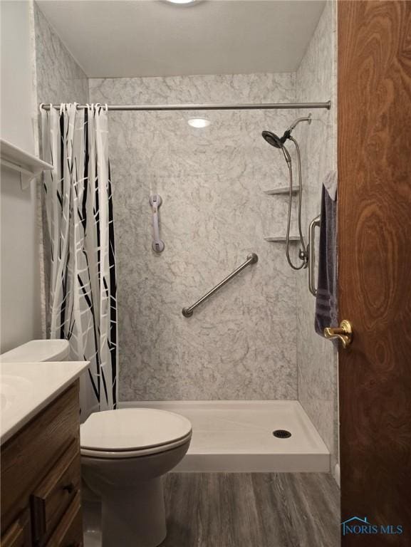 1934 Geffs Ave, Findlay, OH 45840 - bathroom with vanity, wood finished floors, a shower stall, and toilet