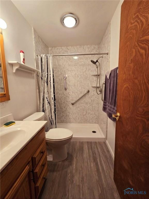1934 Geffs Ave, Findlay, OH 45840 - bathroom with curtained shower, vanity, toilet, and wood finished floors