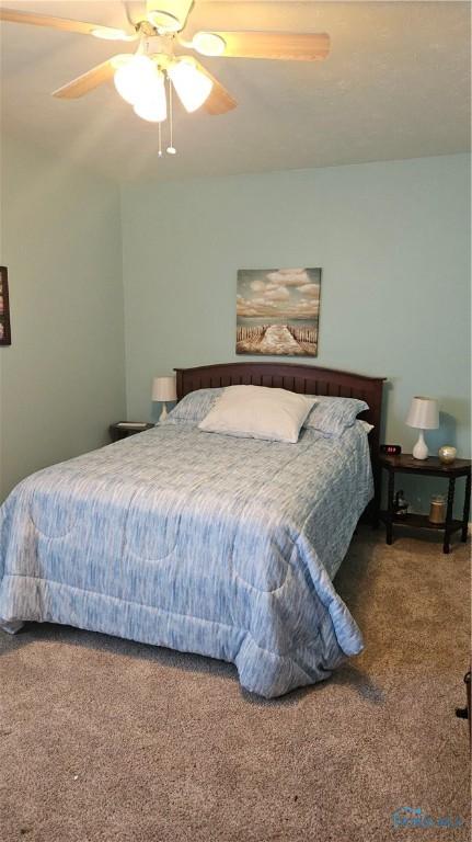 bedroom with ceiling fan and carpet flooring