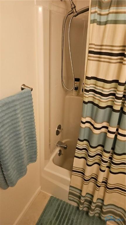 bathroom featuring shower / bathtub combination with curtain