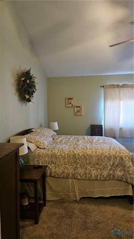 carpeted bedroom with lofted ceiling