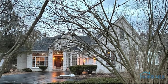 view of front of house with brick siding and aphalt driveway