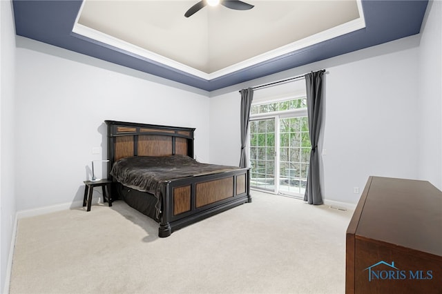 bedroom with baseboards, a raised ceiling, carpet floors, access to exterior, and a ceiling fan