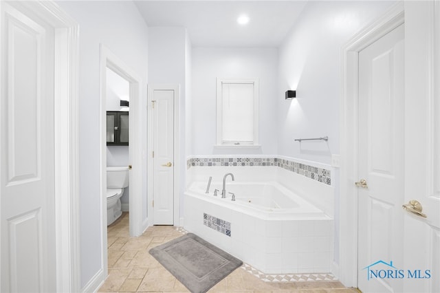 full bath with toilet, a garden tub, and recessed lighting