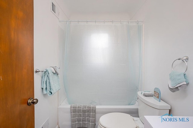 bathroom featuring visible vents, toilet, and shower / tub combo with curtain