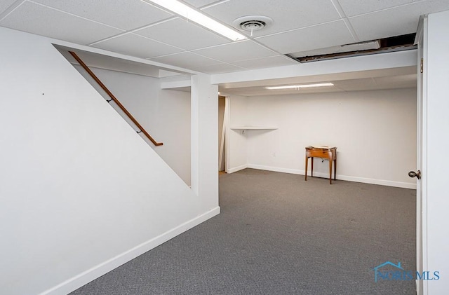 finished basement with visible vents, a drop ceiling, stairway, carpet floors, and baseboards