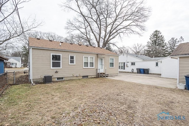 rear view of property featuring fence, entry steps, cooling unit, a yard, and a patio