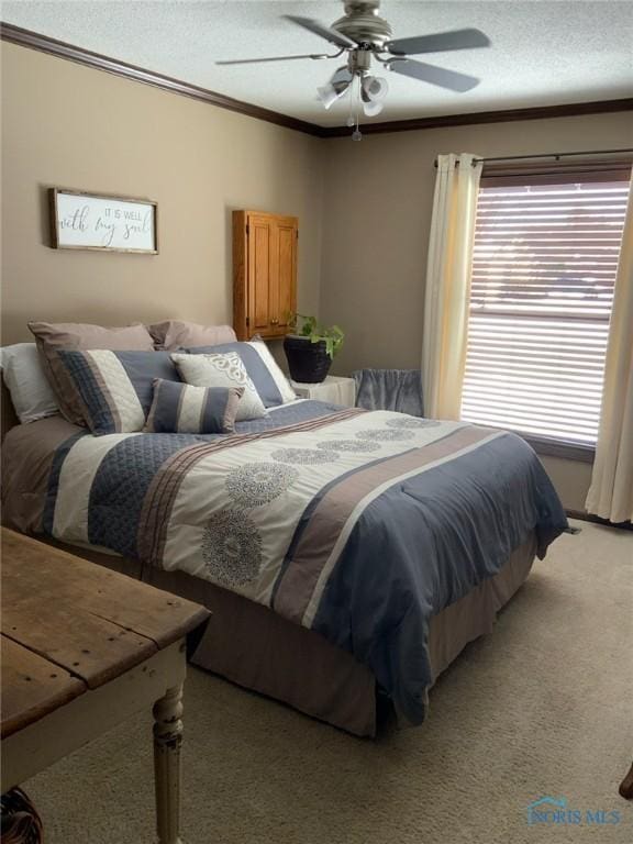 bedroom featuring a textured ceiling, crown molding, ceiling fan, and light carpet