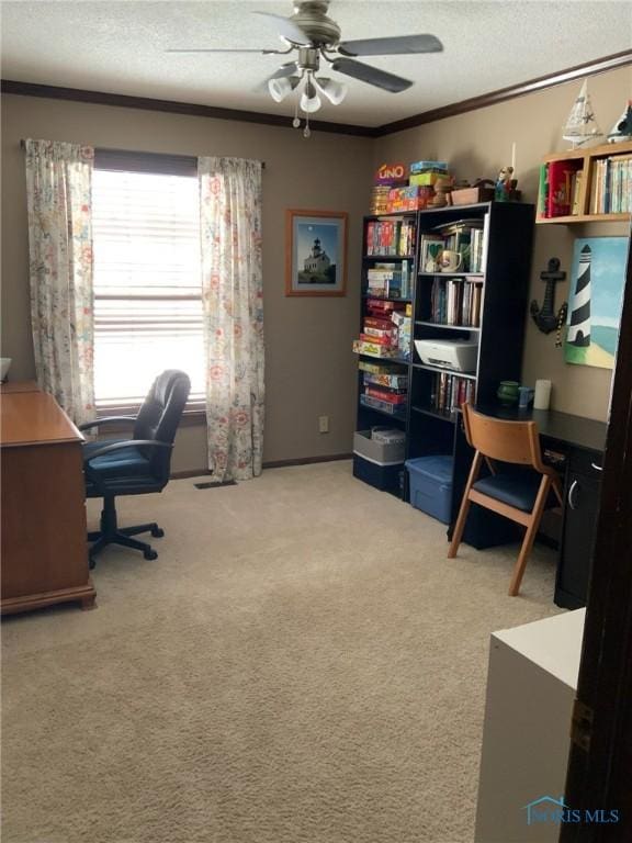 carpeted office with a textured ceiling, crown molding, and a ceiling fan