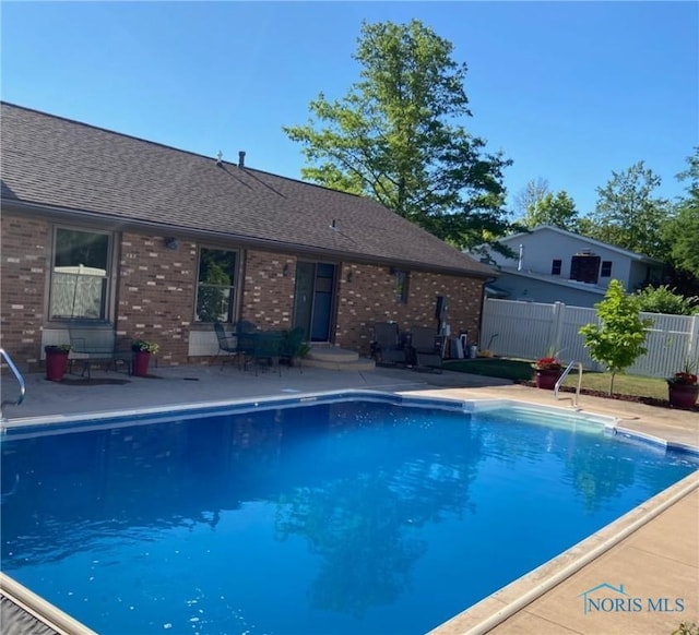 view of pool featuring fence and a patio area