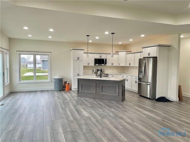 9641 Early Dr, Findlay, OH 45840 - kitchen with baseboards, light countertops, recessed lighting, appliances with stainless steel finishes, and wood finished floors