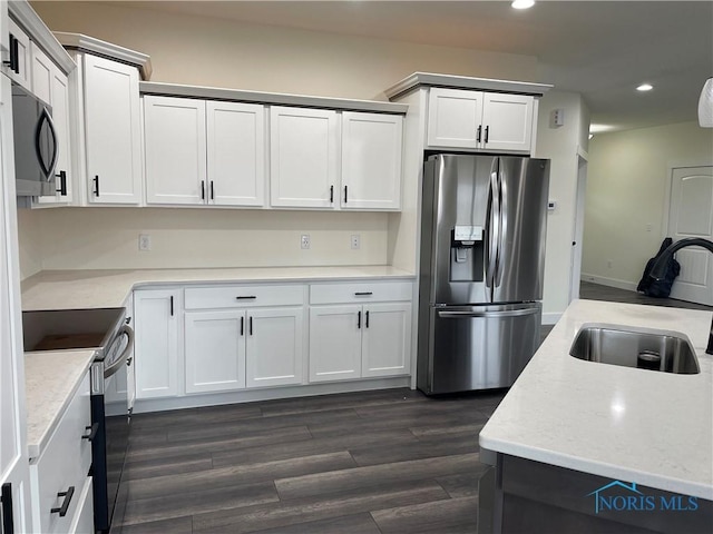 9641 Early Dr, Findlay, OH 45840 - kitchen with dark wood-type flooring, recessed lighting, electric stove, stainless steel fridge, and a sink