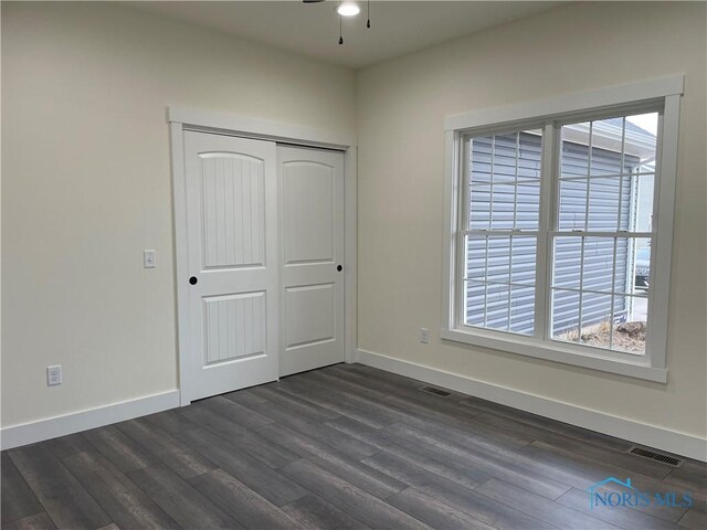 9641 Early Dr, Findlay, OH 45840 - unfurnished bedroom featuring visible vents, baseboards, a closet, and dark wood-style floors