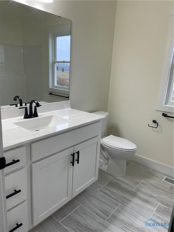 9641 Early Dr, Findlay, OH 45840 - bathroom featuring visible vents, baseboards, toilet, and vanity