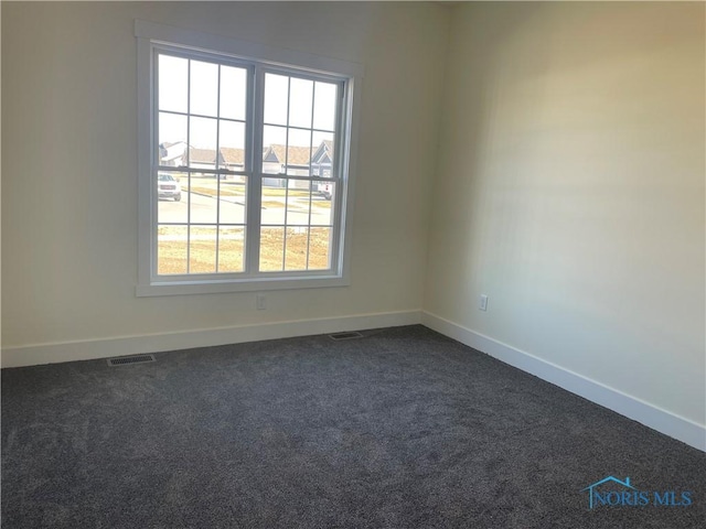 9641 Early Dr, Findlay, OH 45840 - empty room featuring baseboards, visible vents, and dark carpet