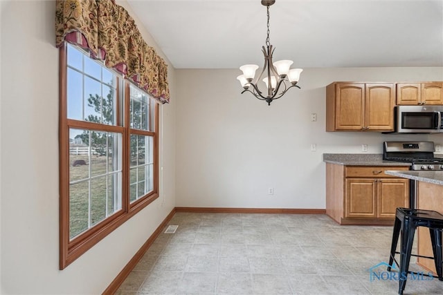14540 Olde Trail Dr, Perrysburg, OH 43551 - kitchen with visible vents, baseboards, an inviting chandelier, stainless steel appliances, and decorative light fixtures