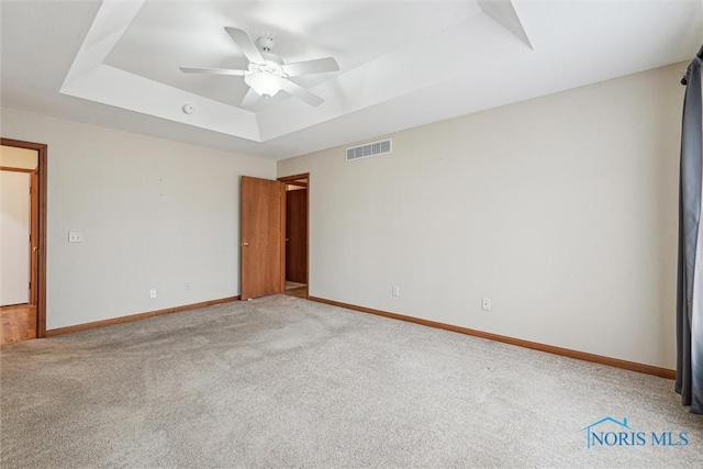 14540 Olde Trail Dr, Perrysburg, OH 43551 - empty room with visible vents, baseboards, carpet floors, a raised ceiling, and a ceiling fan