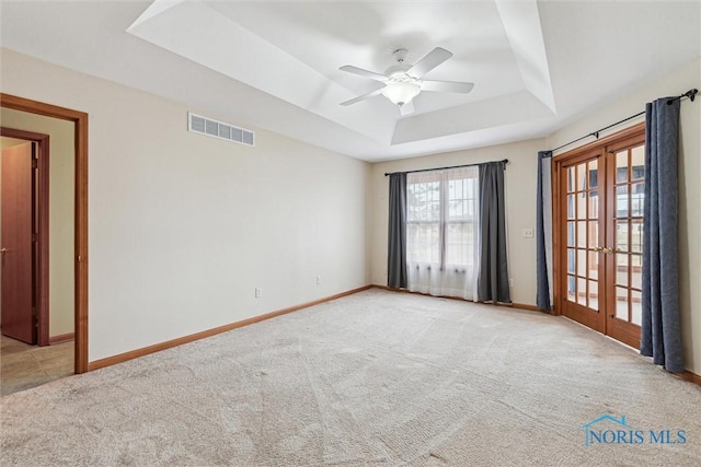 14540 Olde Trail Dr, Perrysburg, OH 43551 - carpeted spare room with a raised ceiling, french doors, visible vents, and baseboards