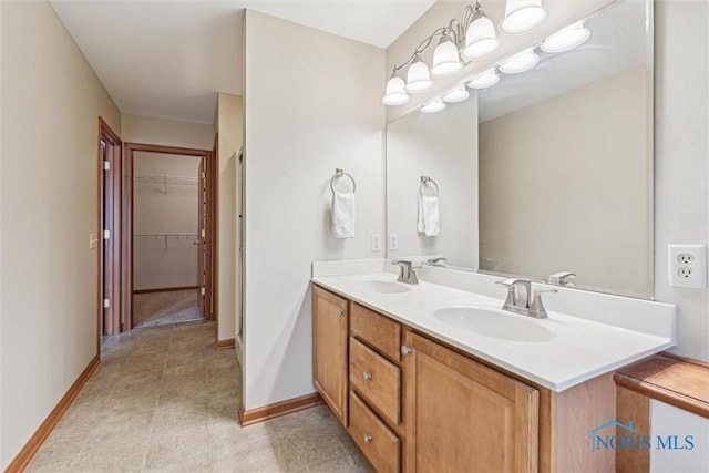 14540 Olde Trail Dr, Perrysburg, OH 43551 - full bathroom with a walk in closet, double vanity, baseboards, and a sink