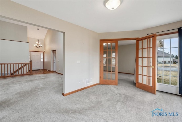 14540 Olde Trail Dr, Perrysburg, OH 43551 - spare room featuring visible vents, carpet floors, baseboards, french doors, and a notable chandelier