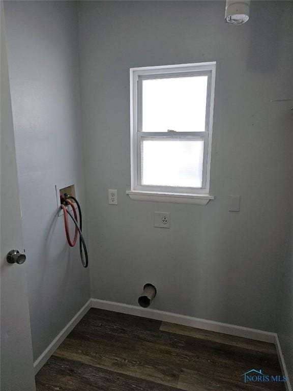 laundry area featuring washer hookup, electric dryer hookup, dark wood finished floors, laundry area, and baseboards