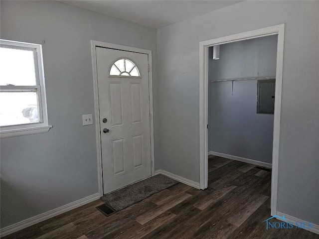 entrance foyer with visible vents, dark wood-type flooring, and baseboards