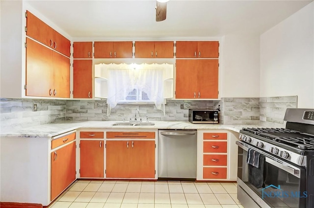 kitchen featuring a sink, stainless steel appliances, decorative backsplash, and light countertops