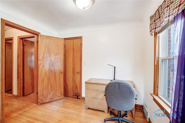 office space with a healthy amount of sunlight, baseboards, and light wood-style floors