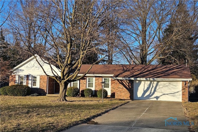 single story home with concrete driveway, a garage, brick siding, and a front lawn