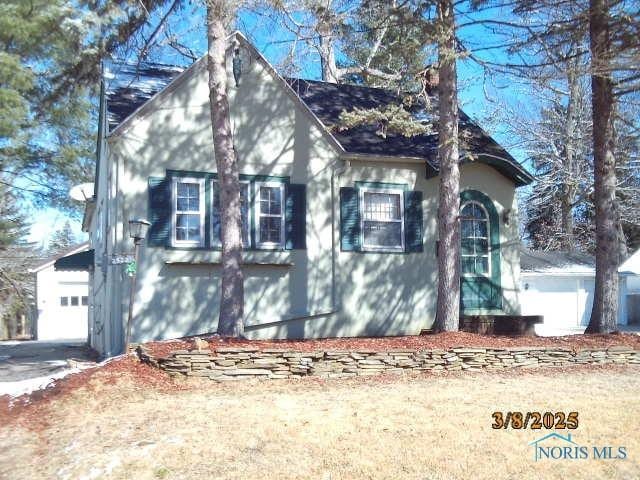 view of side of home featuring driveway and a garage