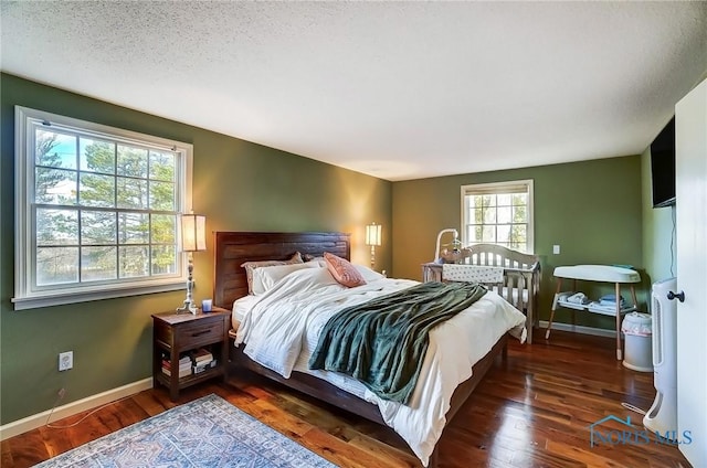 bedroom featuring baseboards and wood finished floors